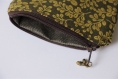 Porte-monnaie feuilles dorées sur fond marron avec intérieur gris et breloque glands