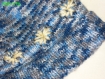 Bonnet en laine chinée bleue, grise et blanche orné de fleurs blanches 