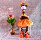 Gigi, la girafe, est réalisée en polaire ,petite jupe et foulard en tissu orange à pois blancs