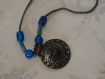 Collier en perles ethniques et pendentif en métal